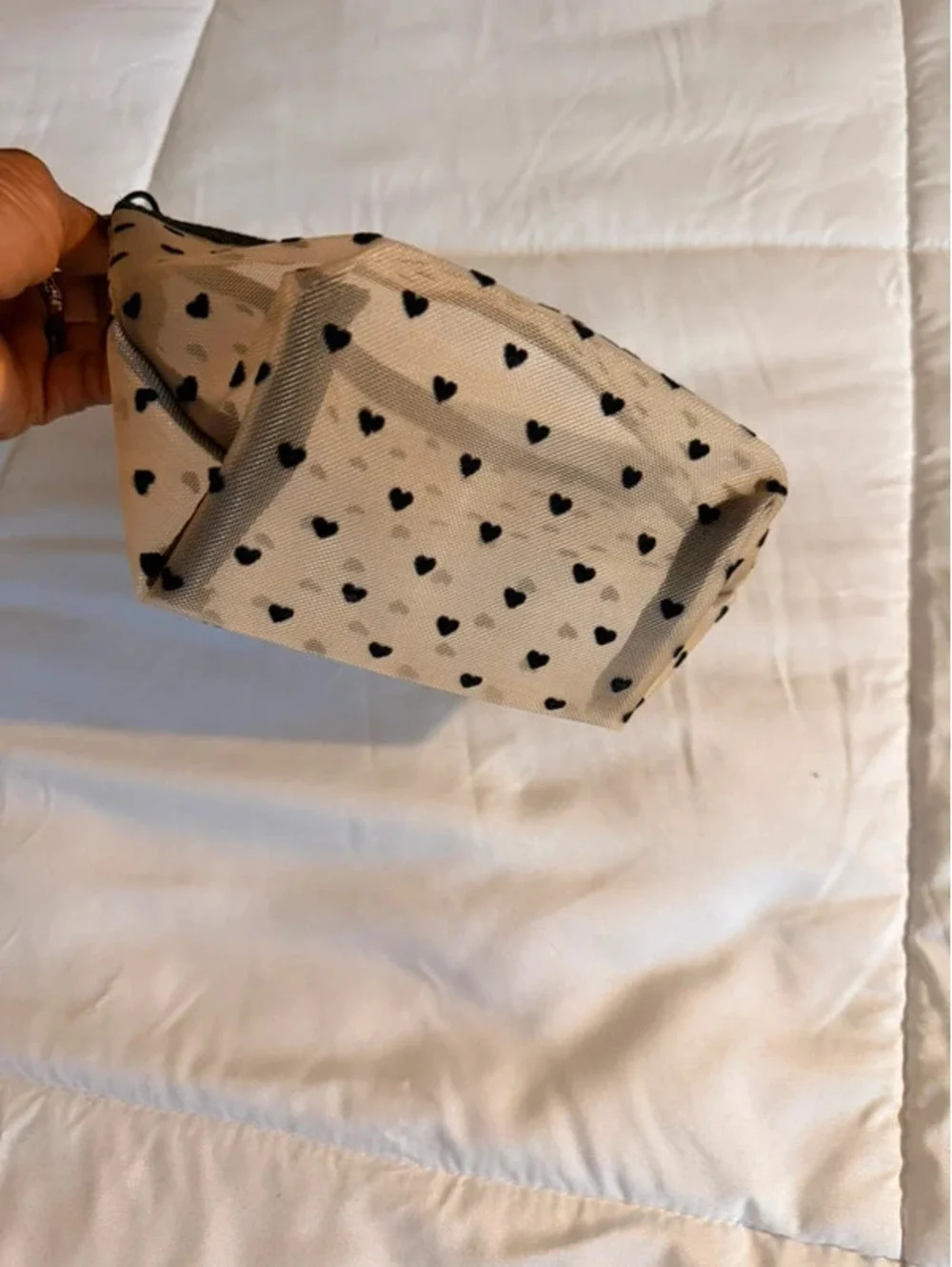 Black heart mesh pouch with black heart pattern on beige